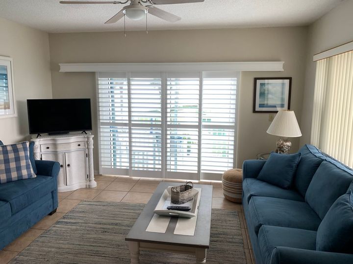 A room with a desk, chair, computer and shutters on the windows — Deland, FL — Island Shutter Company