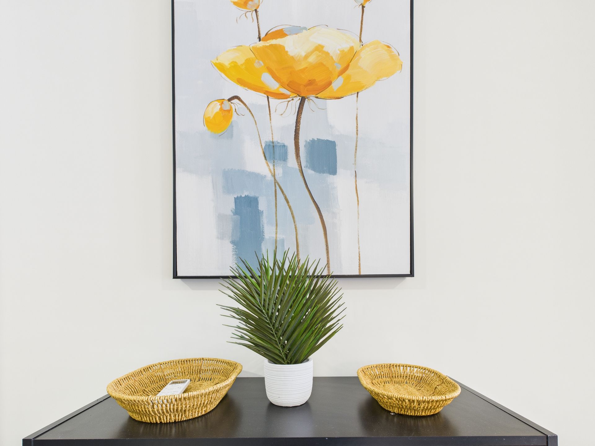 Black table with yellow flower art and decor.