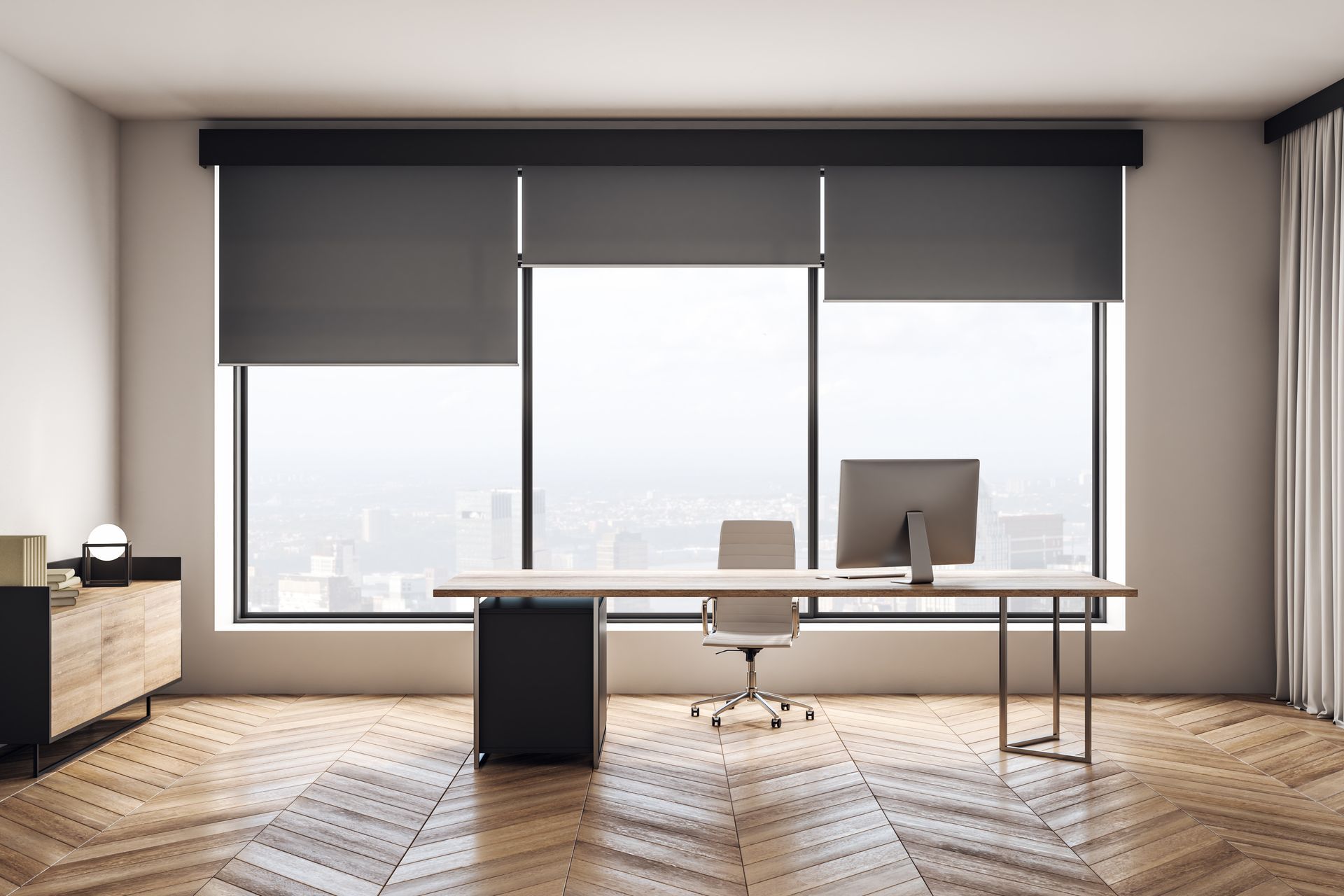 Modern office interior with a desk, chair, and large windows with dark blinds.