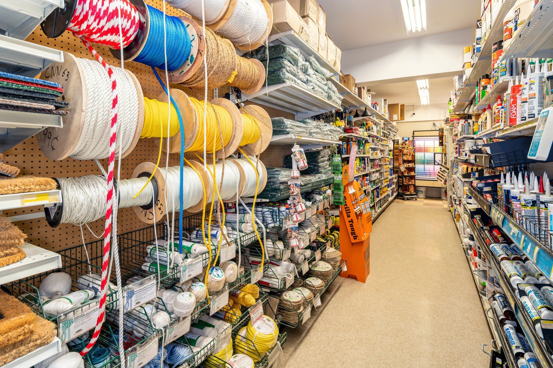 A store aisle filled with lots of rope and other items.