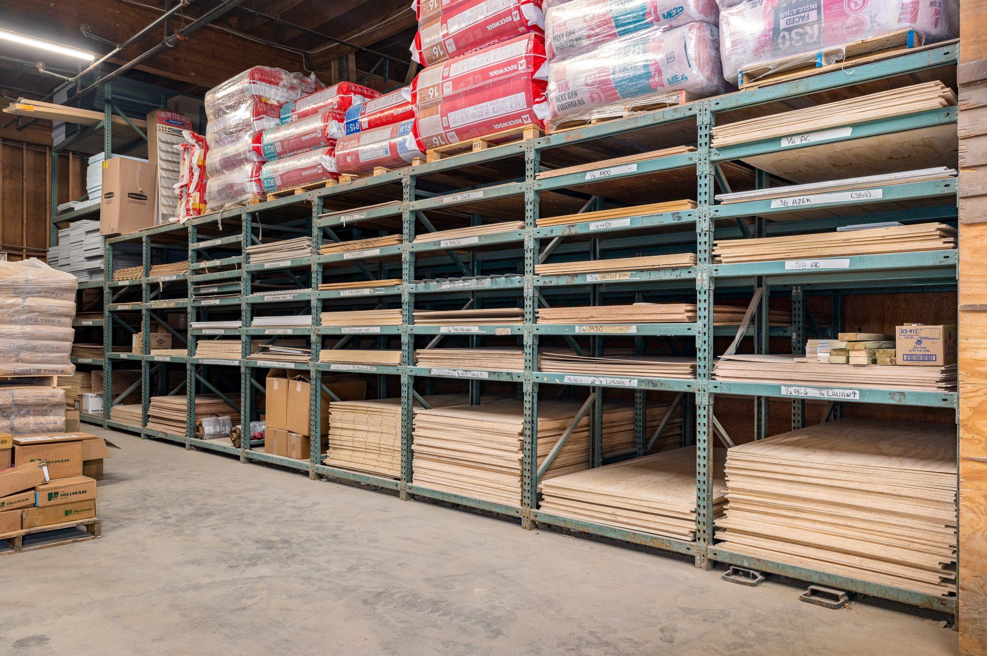 A large warehouse filled with shelves filled with lots of wood.