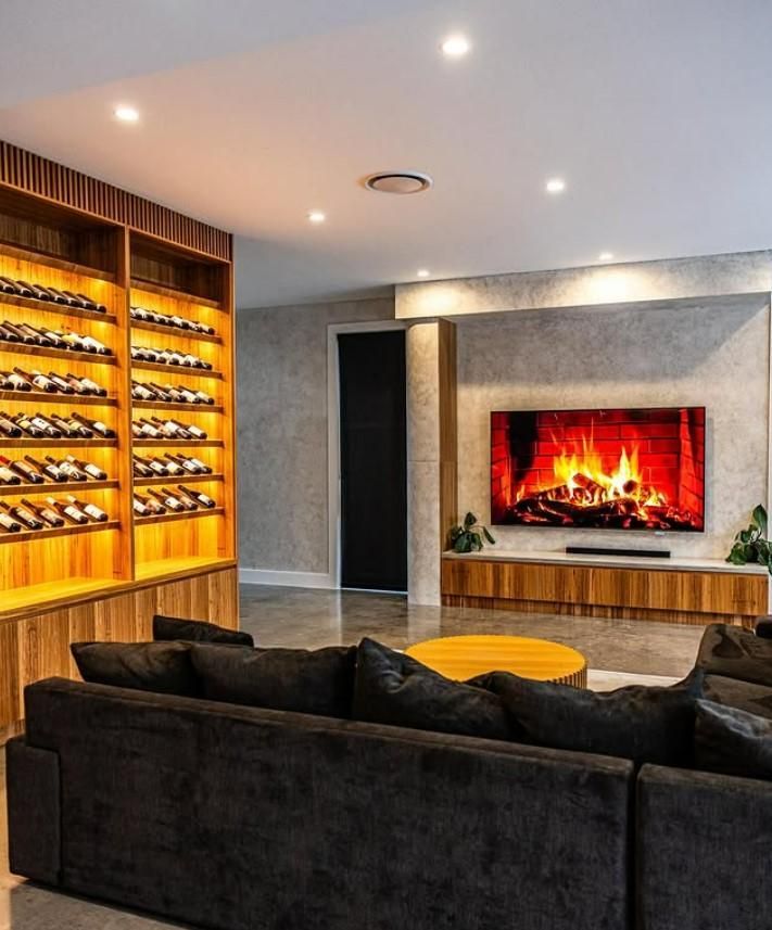 A Living Room With a Fireplace and a Couch — JMB Electrical Services In Kiama, NSW