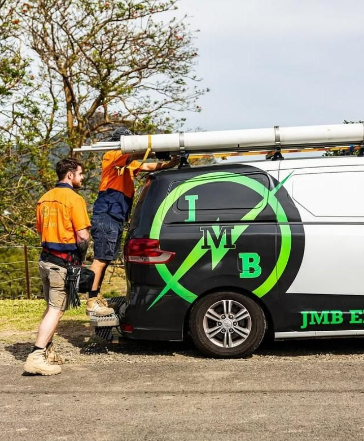 Two Men Are Working on the Roof of a Van — JMB Electrical Services In Port Kembla, NSW