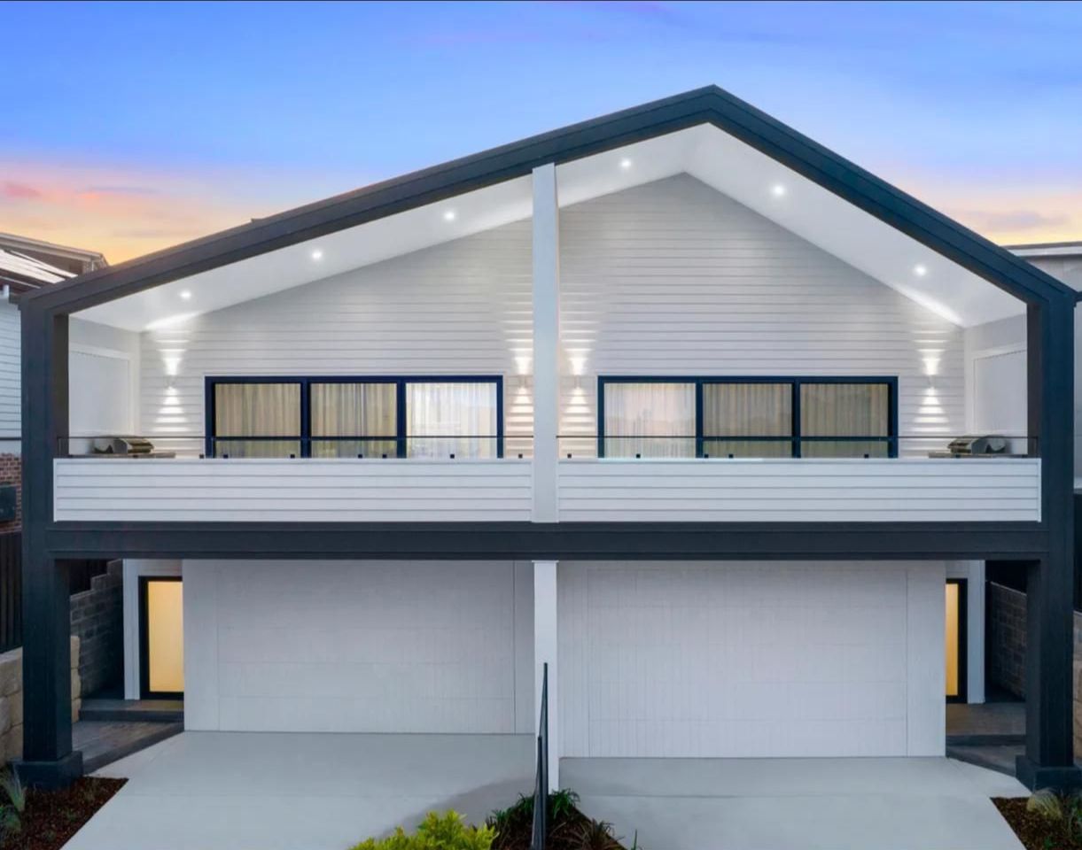A White House With a Black Roof and a Balcony — JMB Electrical Services In Port Kembla, NSW