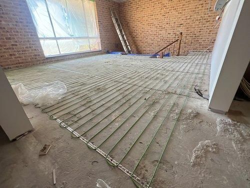 A Room With a Brick Wall and a Heater on the Floor — JMB Electrical Services In Port Kembla, NSW