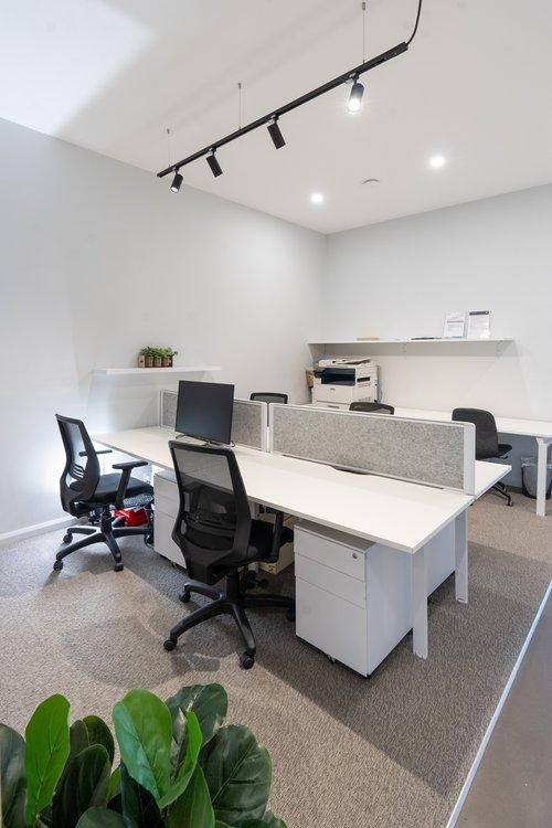 A Room With a Lot of Desks and Chairs in It — JMB Electrical Services In Shellharbour, NSW