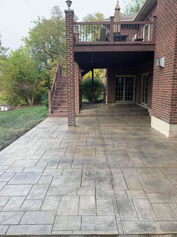 A patio with a deck and stairs leading up to it