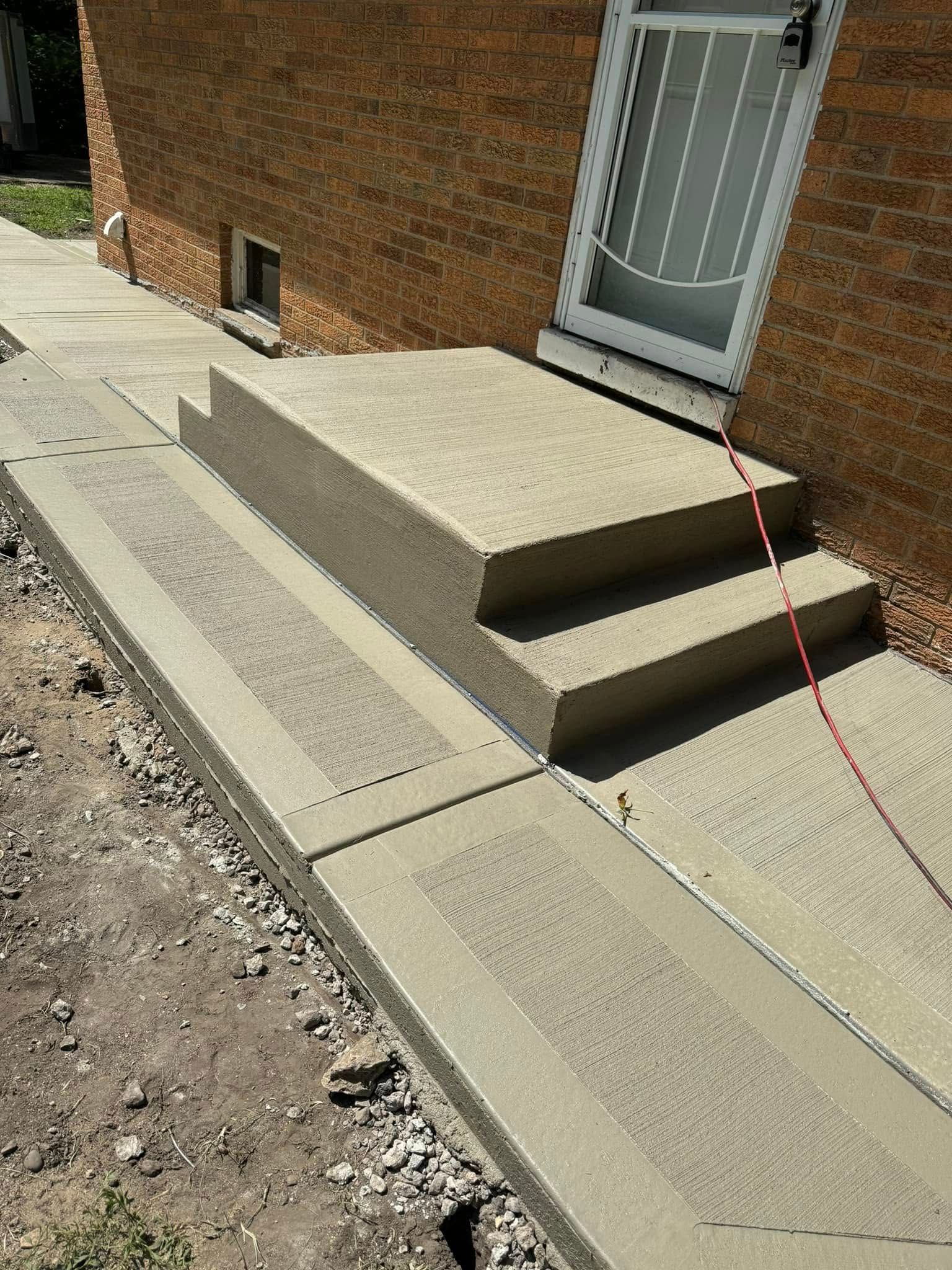 A brick building with concrete steps leading up to it.