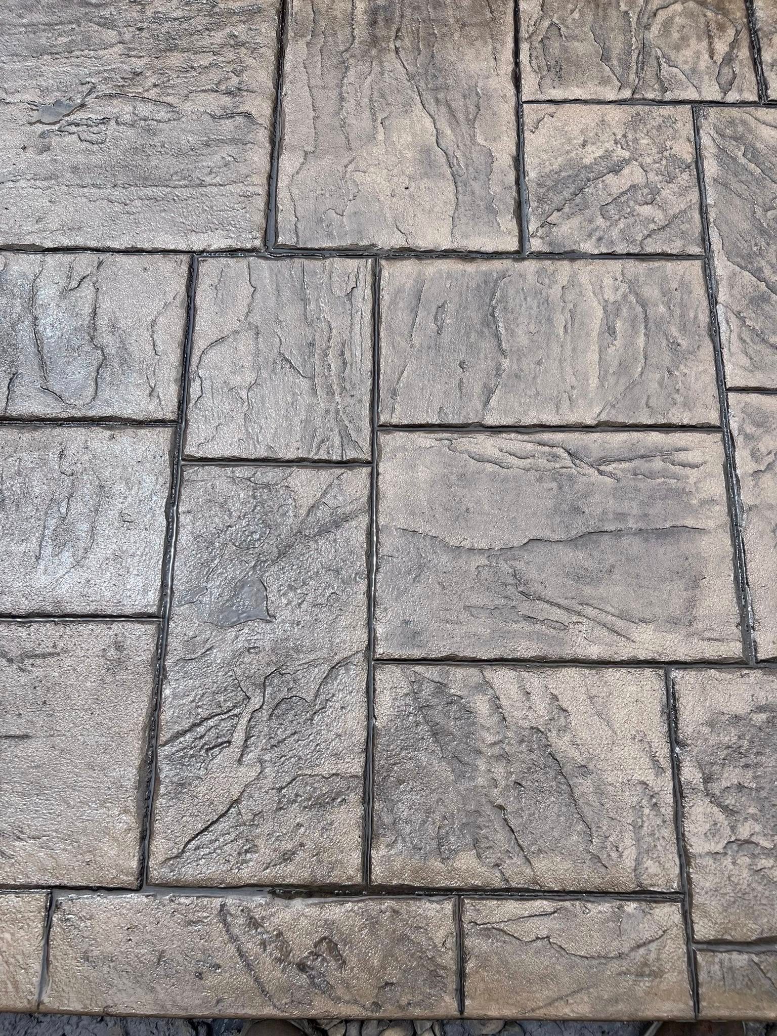 A close up of a brick floor with a brick pattern.