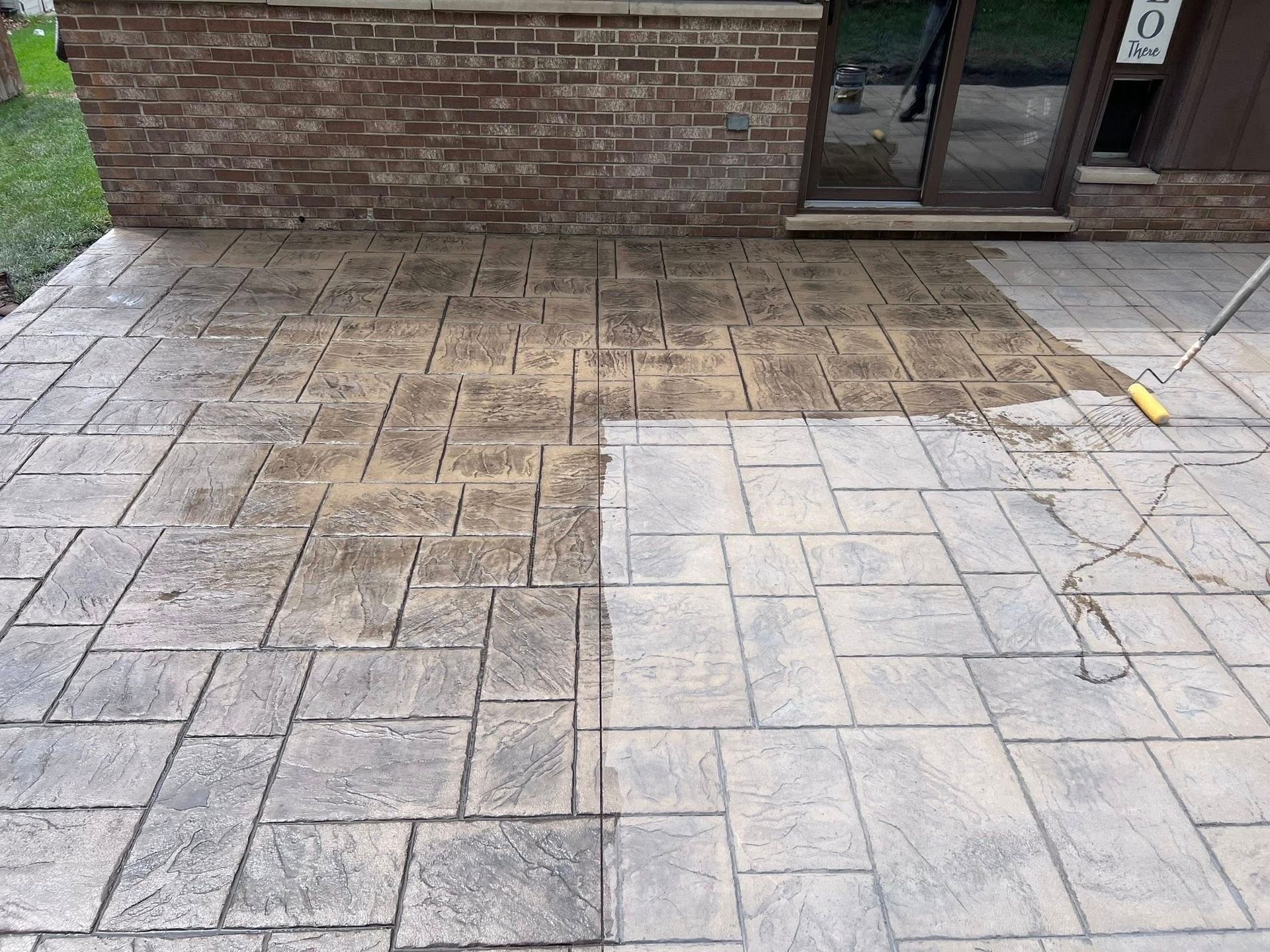 A before and after picture of a concrete patio being cleaned.