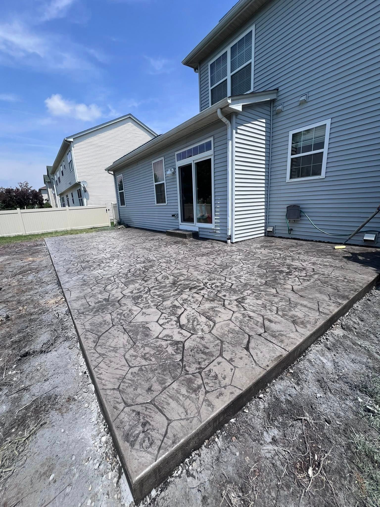A house with a concrete patio in front of it.