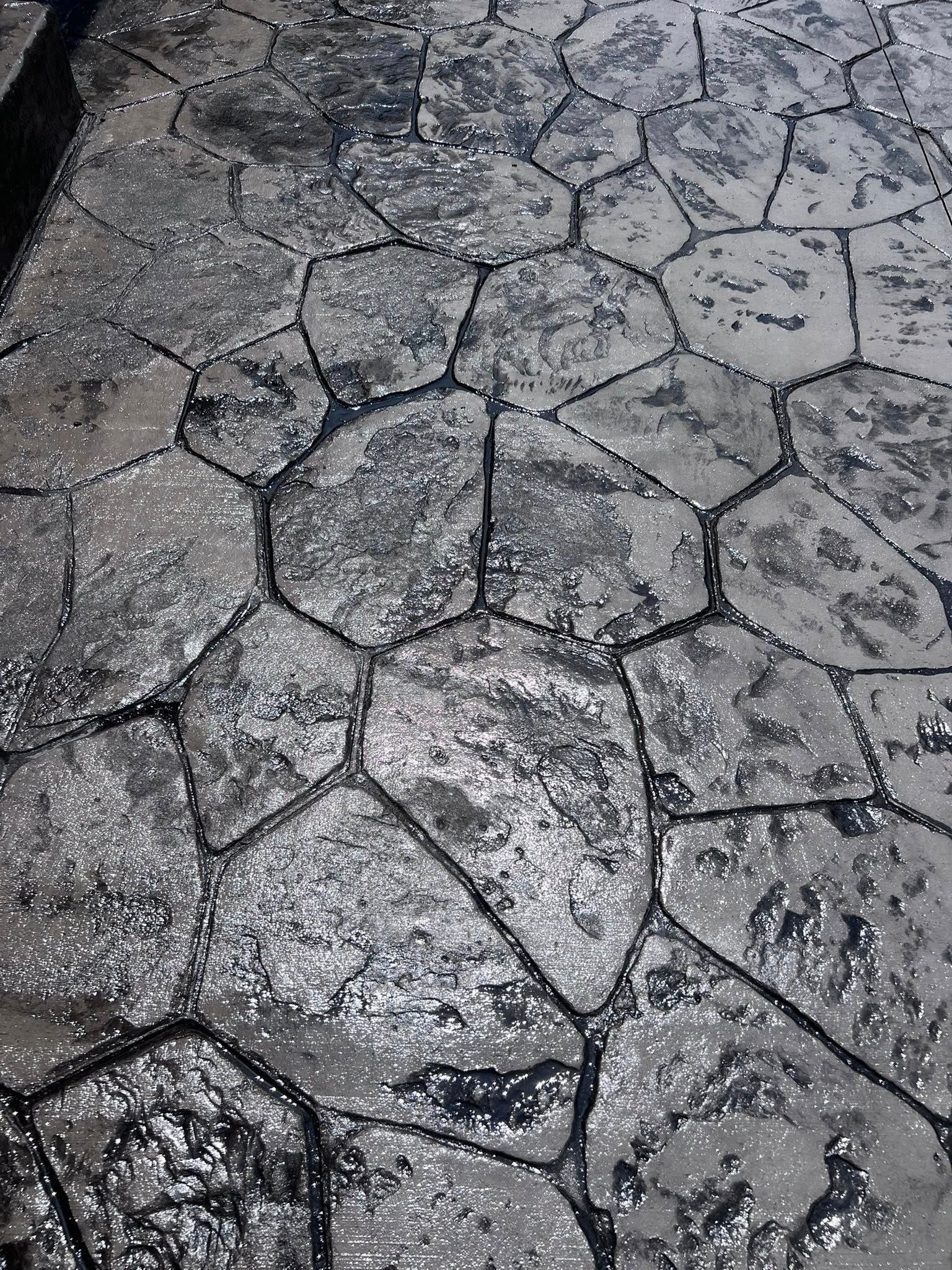 A close up of a concrete floor with a geometric pattern.