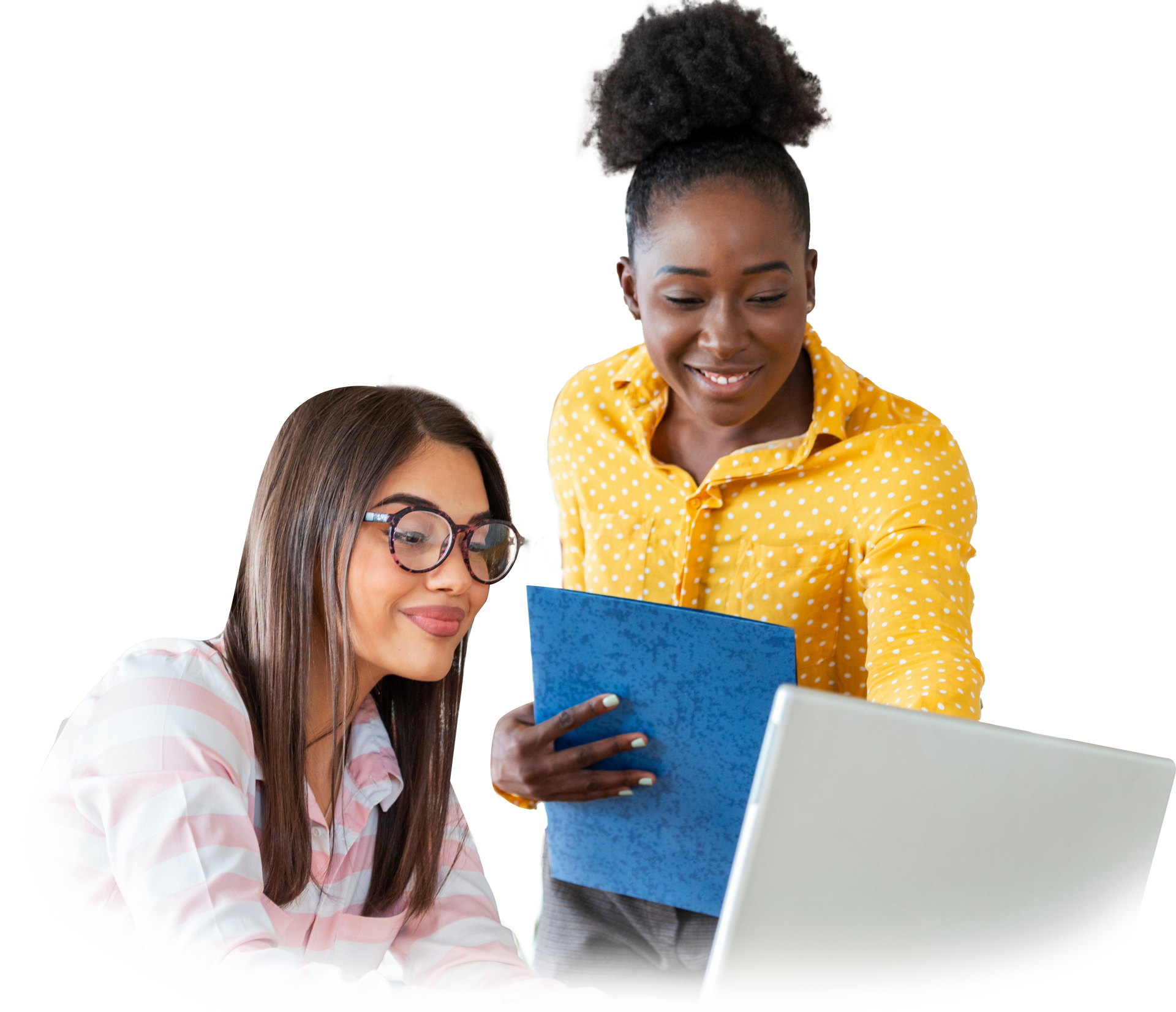 Two women are looking at a laptop together and smiling.