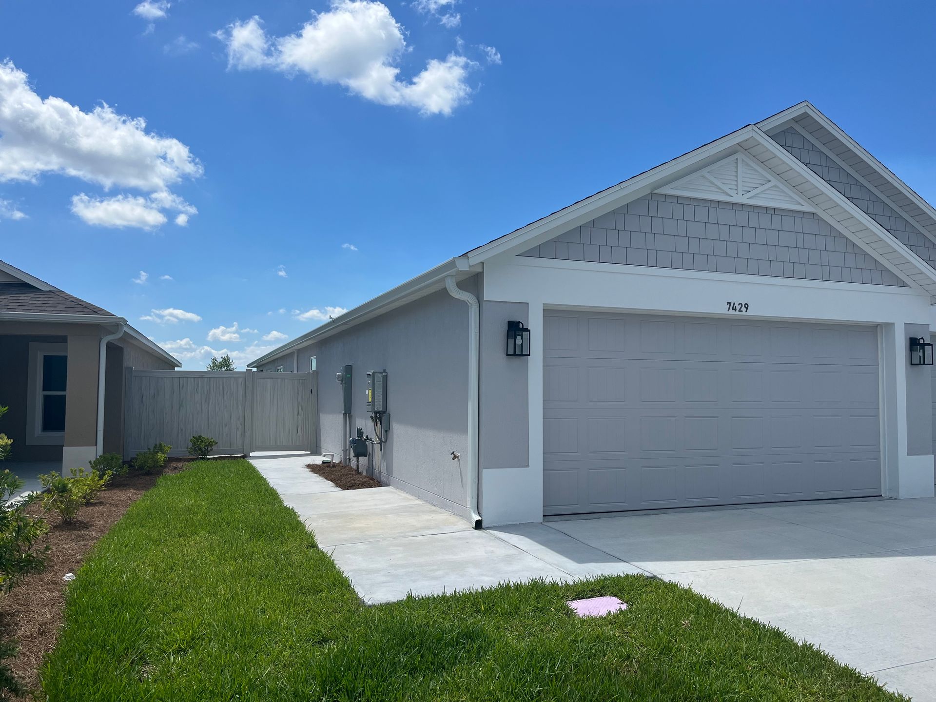 A large white house with a palm tree in front of it
