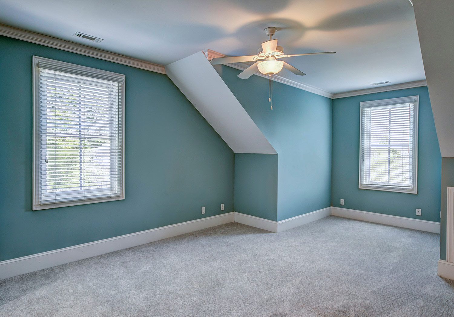 Empty blue bedroom with carpet