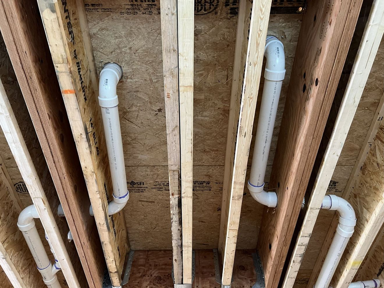 Commercial kitchen with stainless steel appliances, including a range, fryer, and hood.