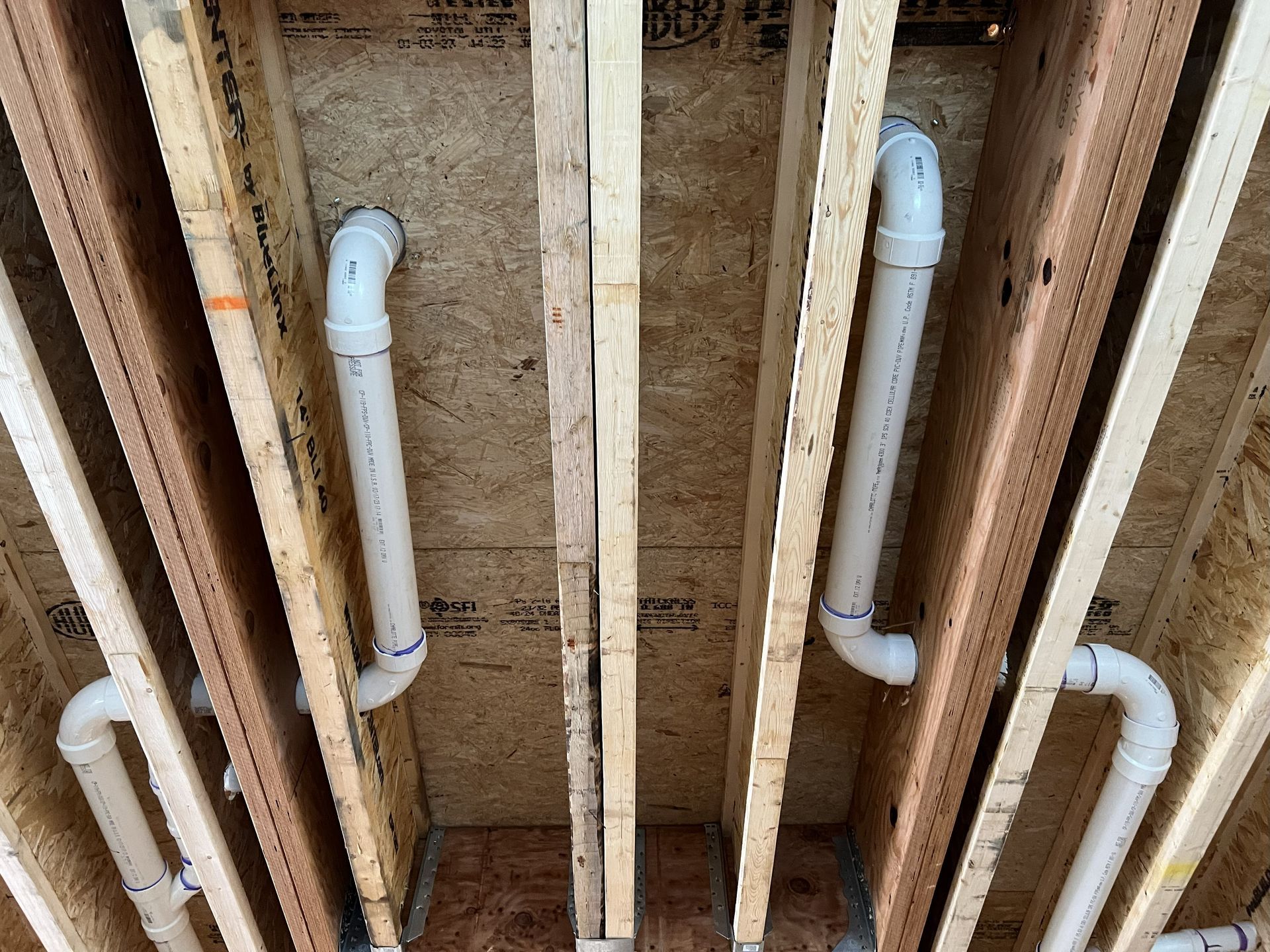 Commercial kitchen with stainless steel appliances, including a range, fryer, and hood.