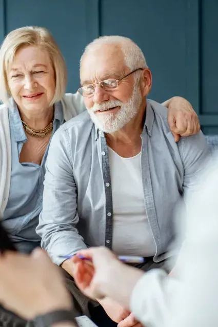 A man and a woman are sitting next to each other on a couch.