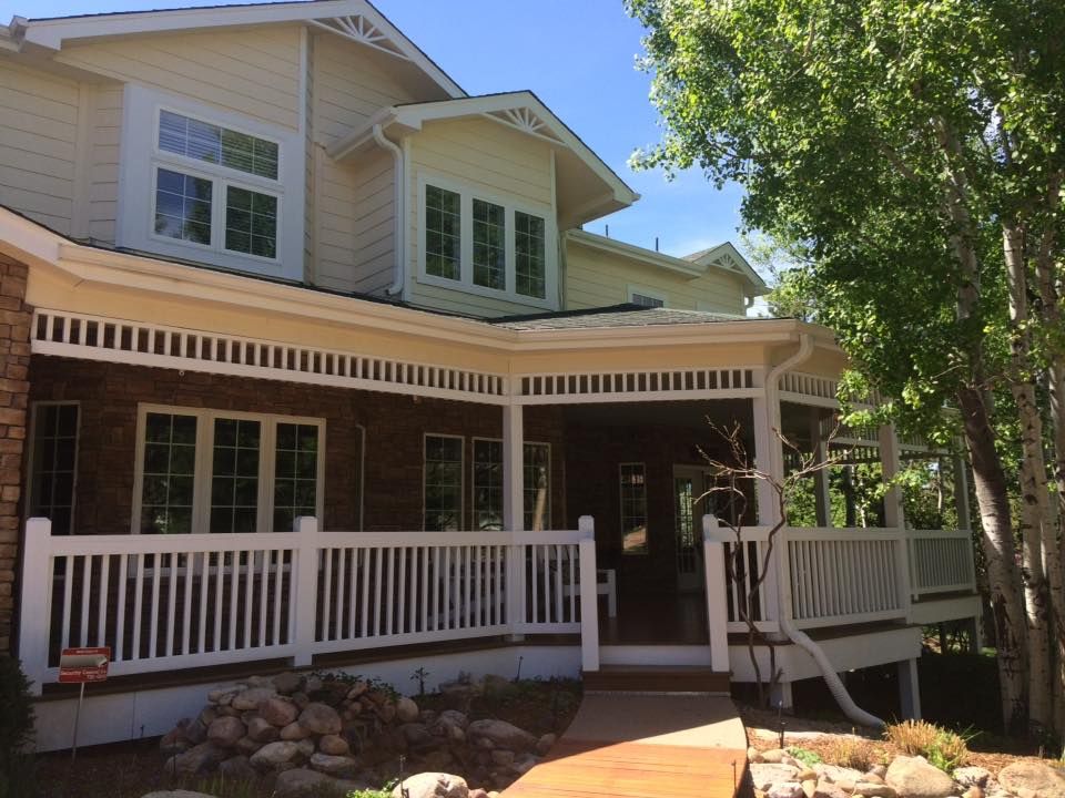 A house with a large porch and a white railing