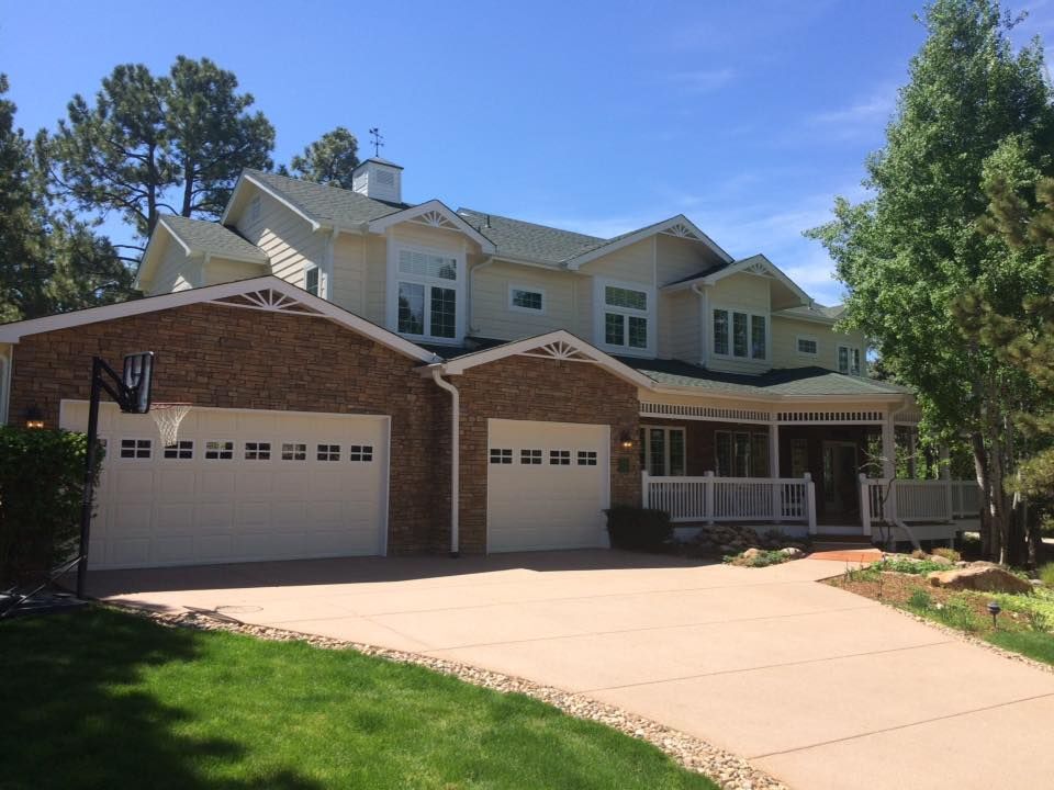 A large brick house with a white garage door