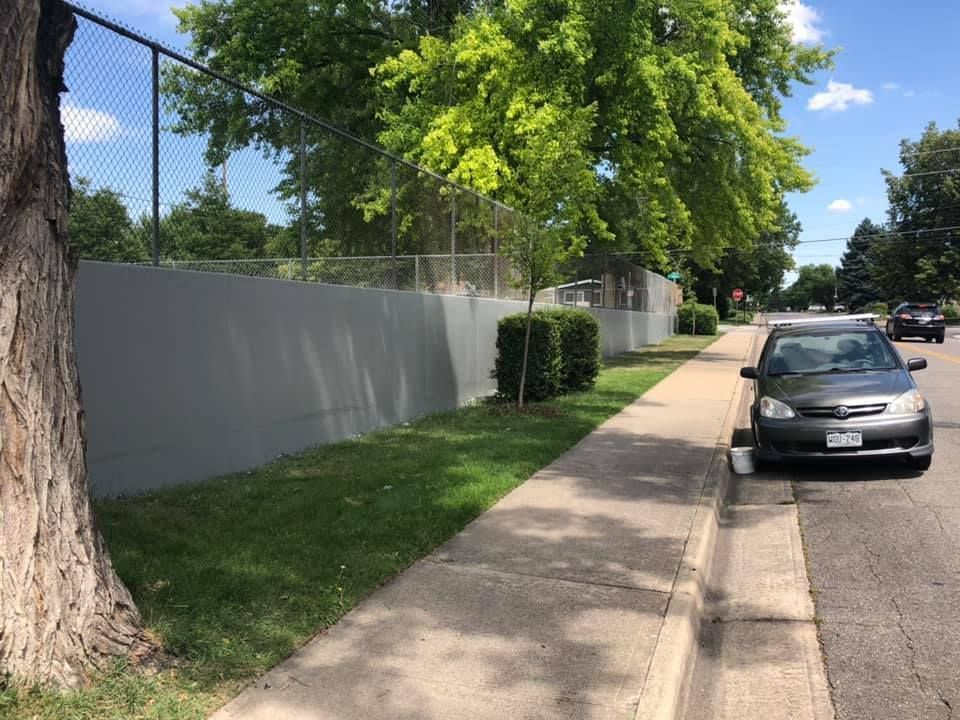 A car is parked on the side of the road next to a sidewalk