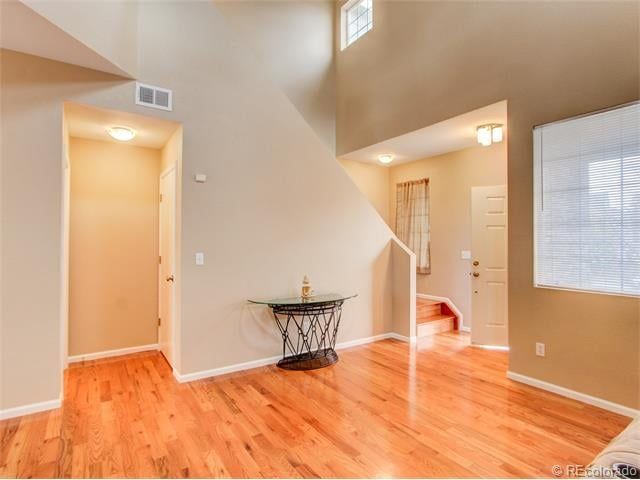 An empty living room with hardwood floors and stairs