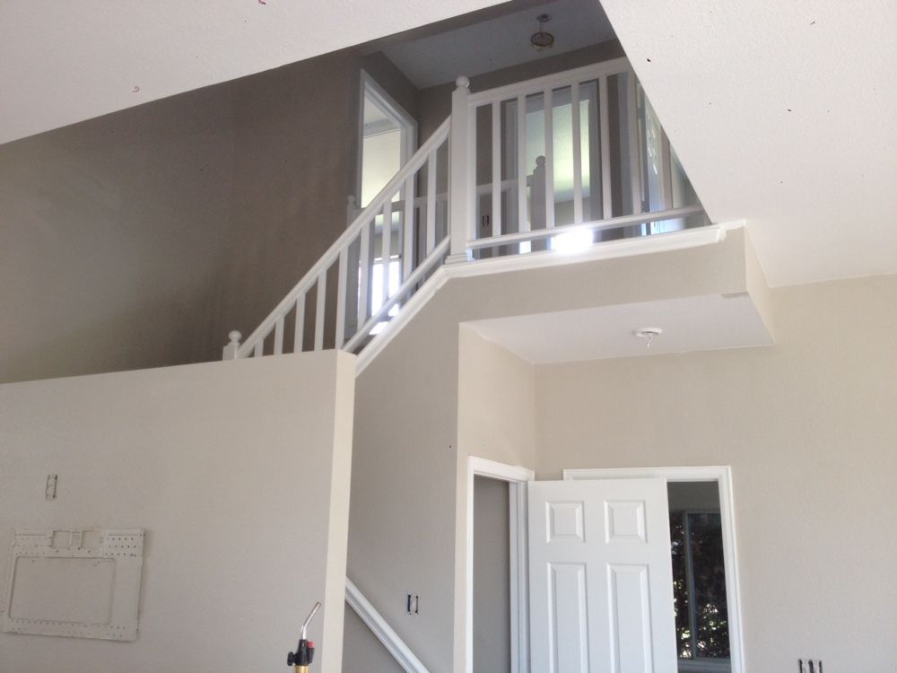 An empty room with stairs leading up to the second floor
