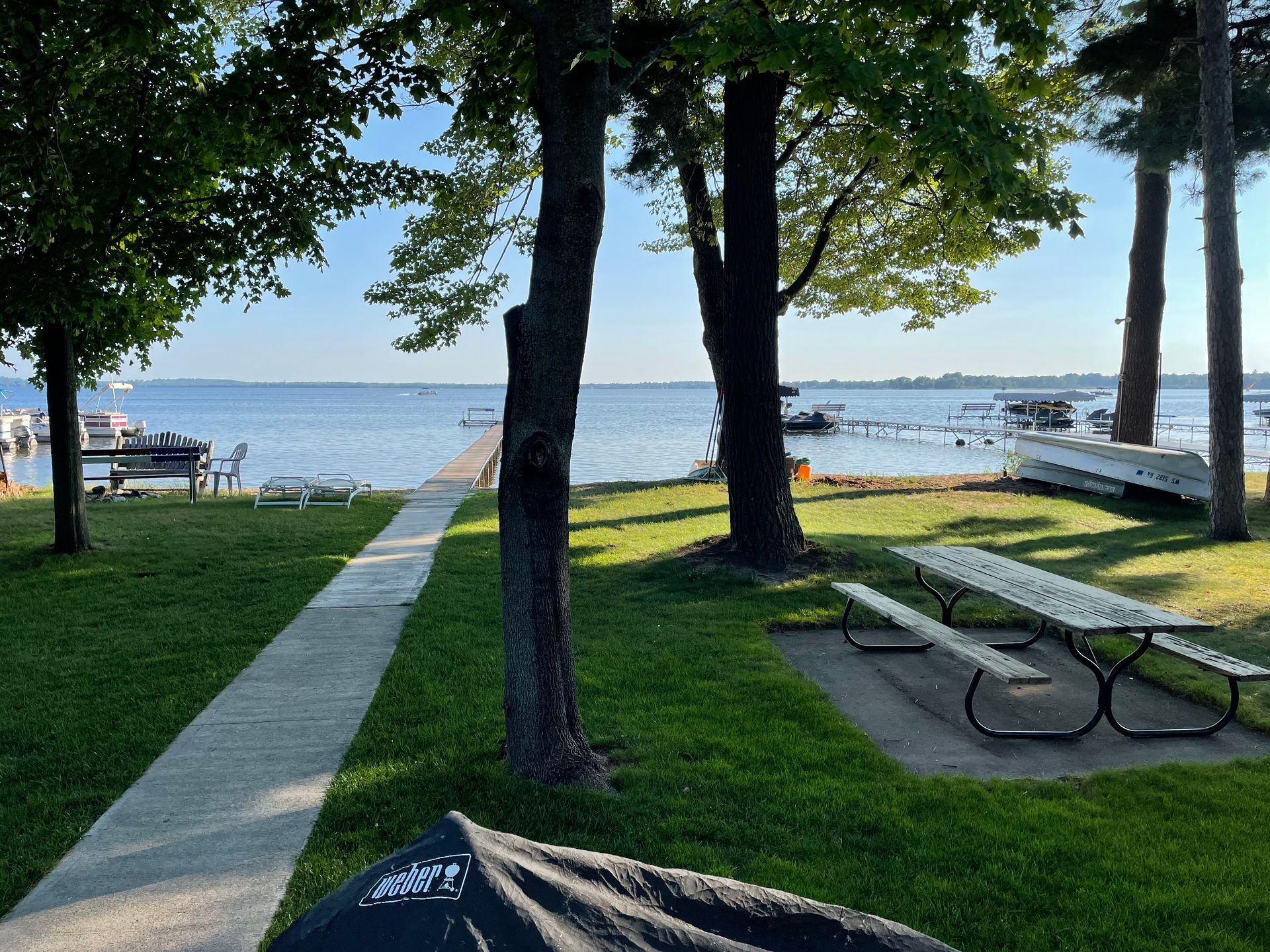 A picnic table in a park next to a body of water