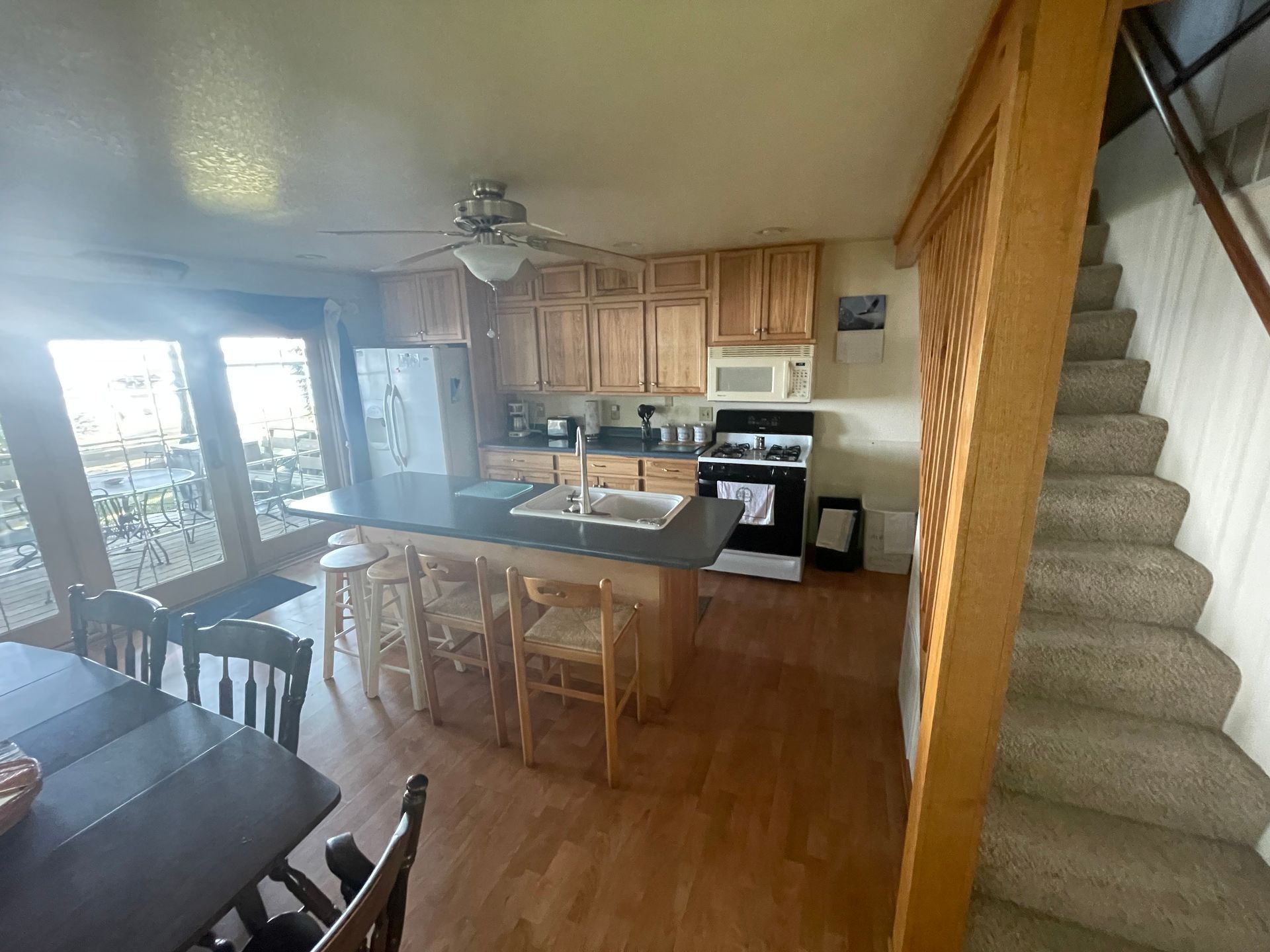 A kitchen with a staircase leading up to the second floor