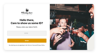 Whiskey bottles of various brands and ages, arranged on a shelf with warm lighting.