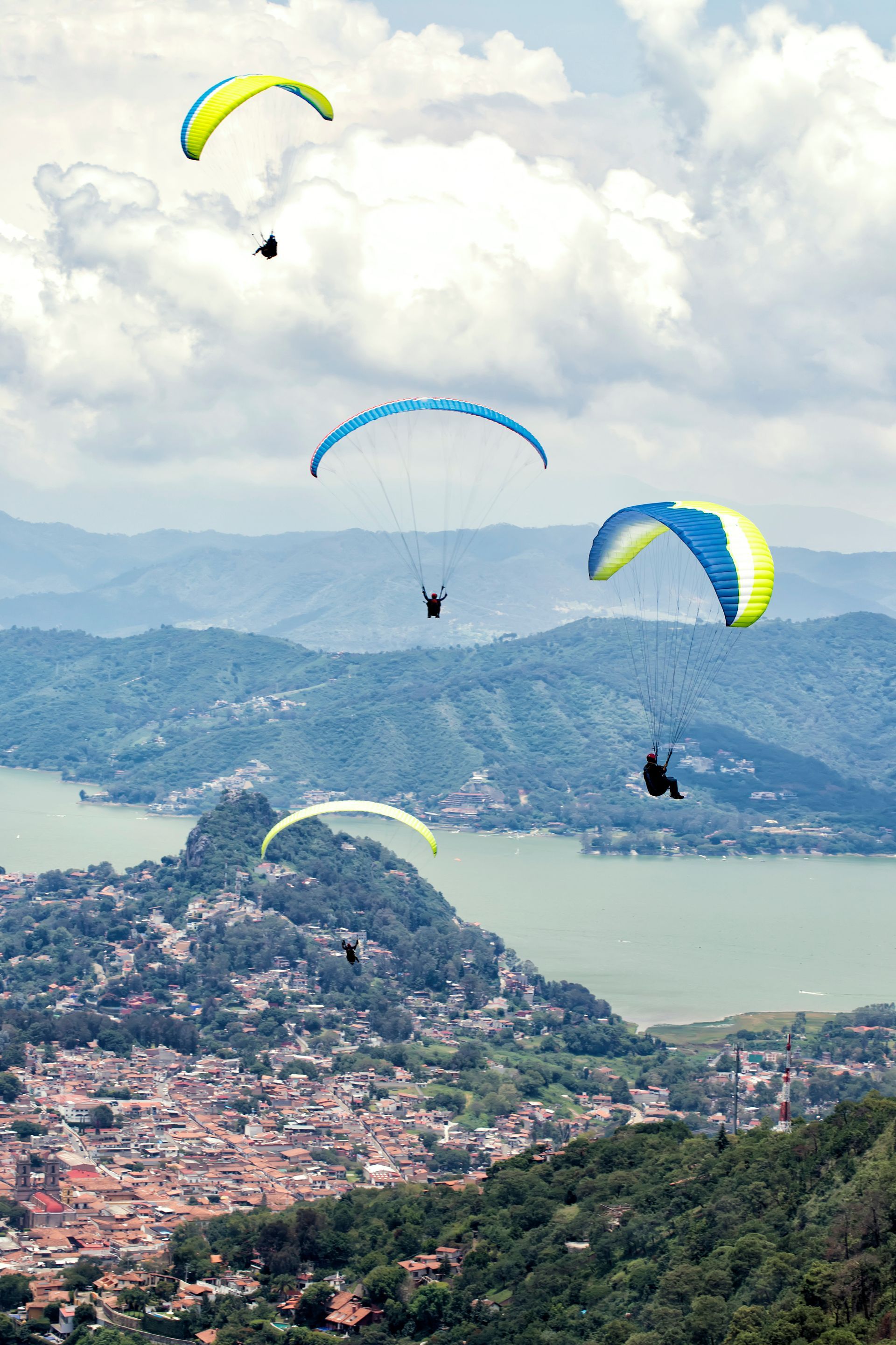 A group of people parasailing over a lake
