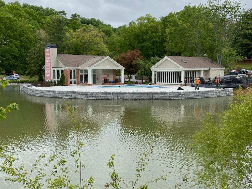 A house sits on a floating island in the middle of a lake