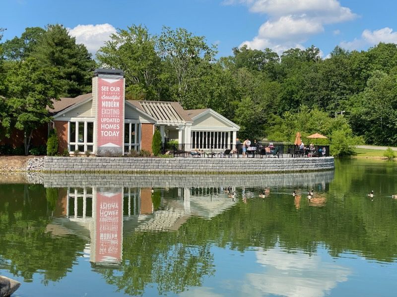 A house is sitting on the shore of a lake.