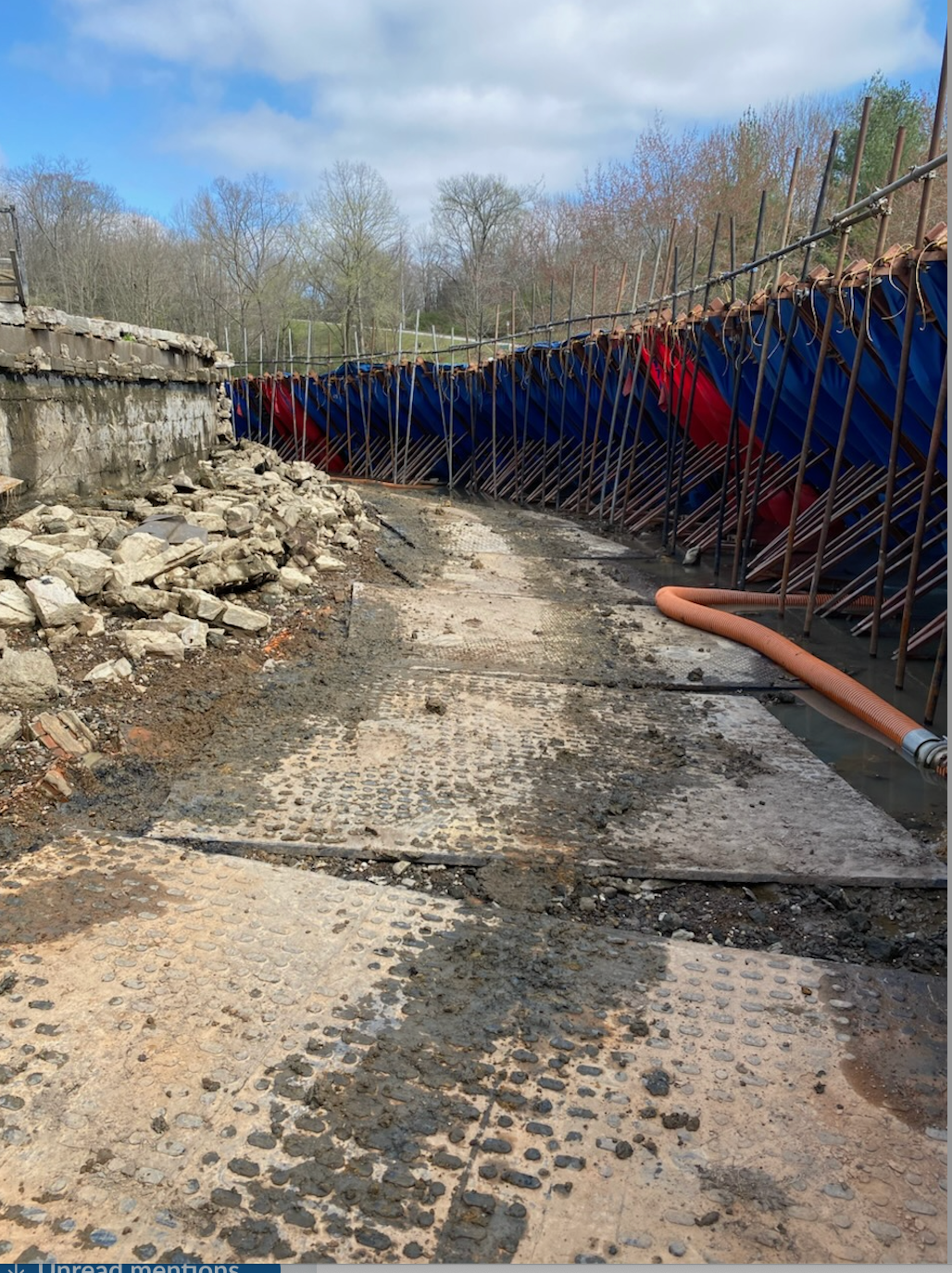 A dirt road with a hose in the middle of it.