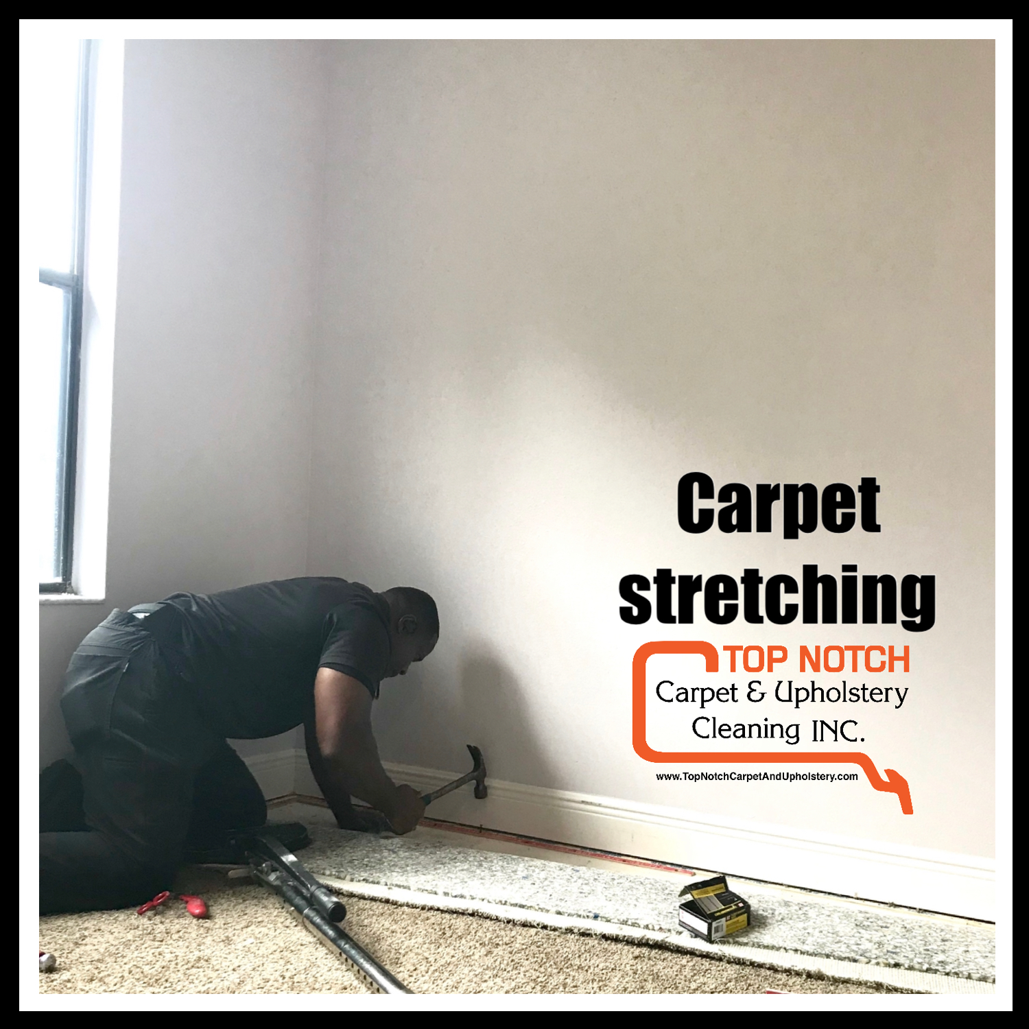 A man kneeling, hammering carpet near the wall. 