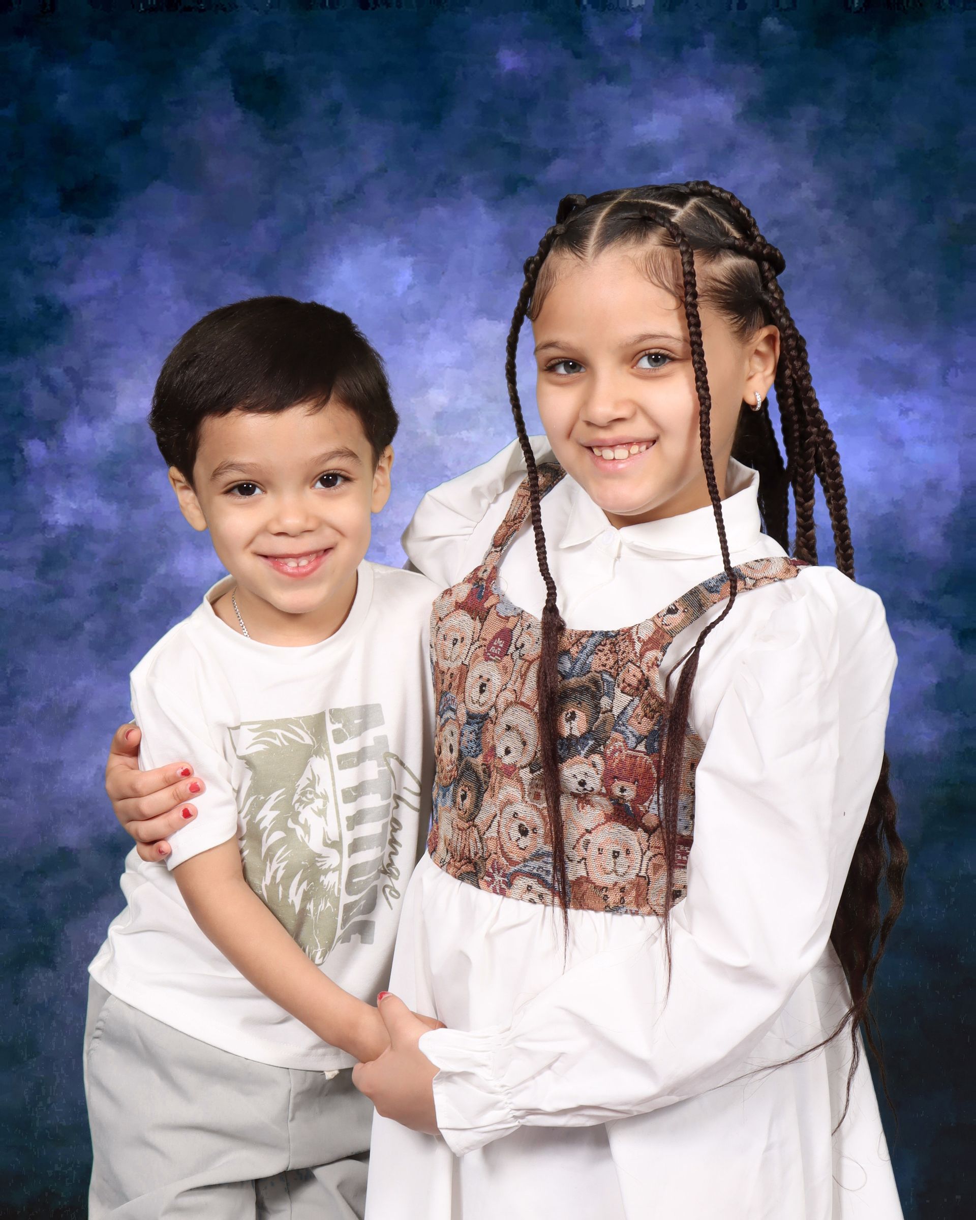 A boy and a girl are posing for a picture together