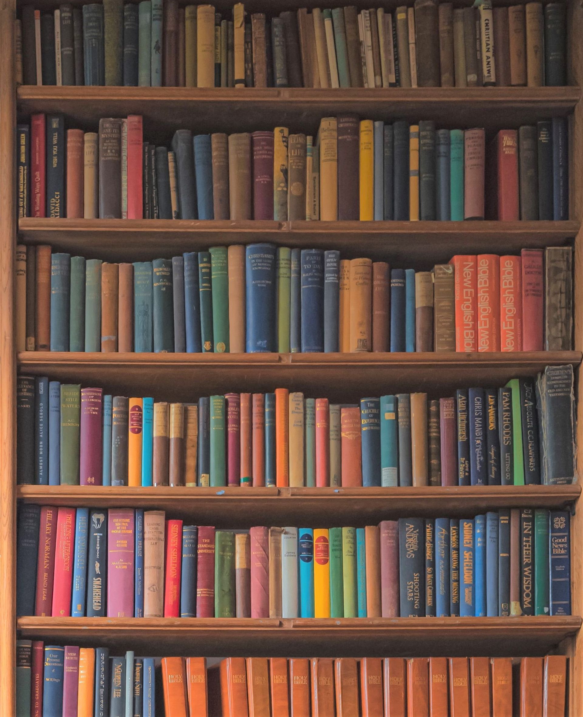 A bookshelf filled with lots of books including the encyclopedia