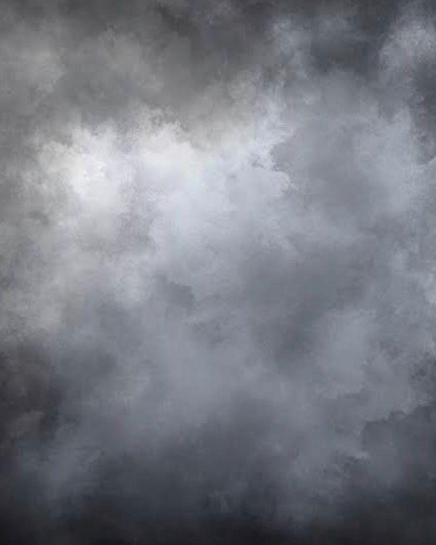 A dark cloudy sky with a few white clouds in it