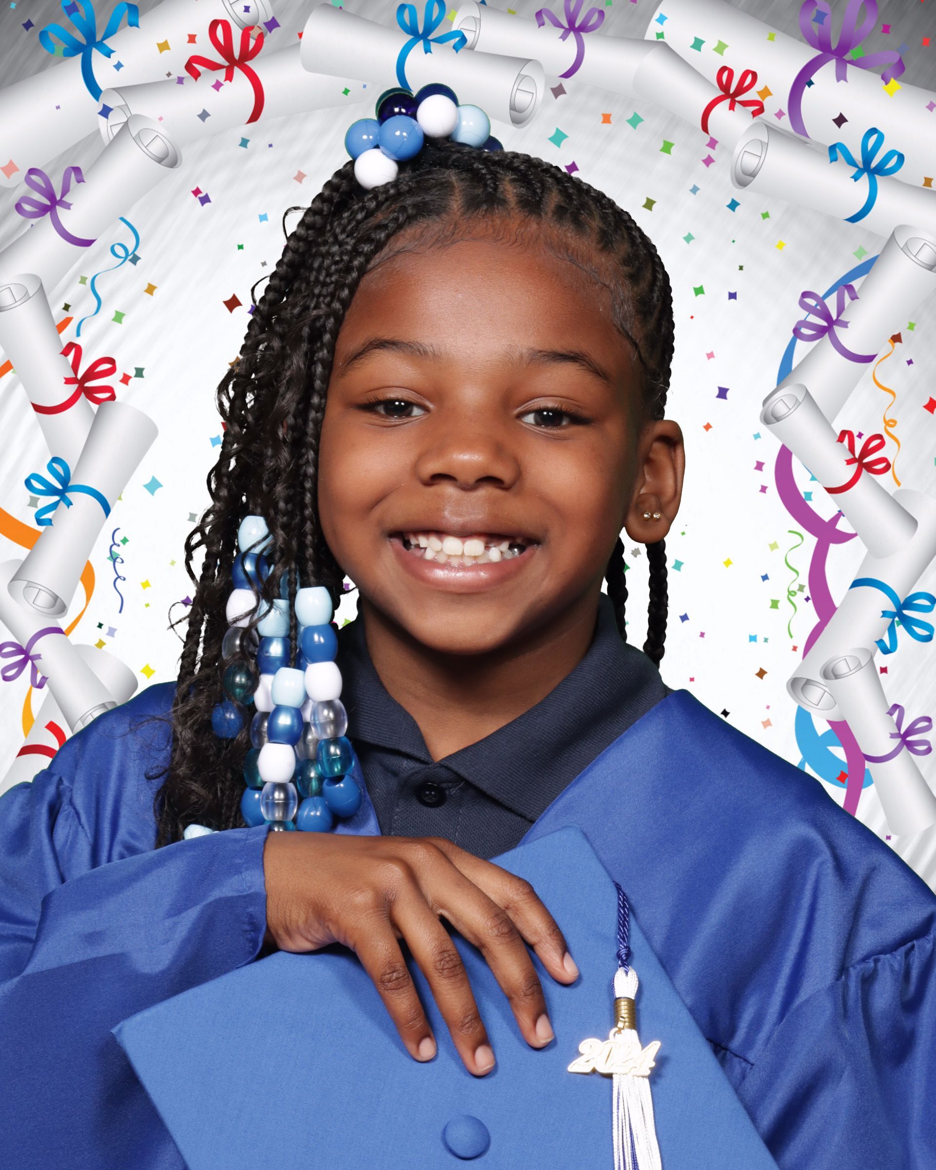 A young girl in a graduation cap and gown is smiling