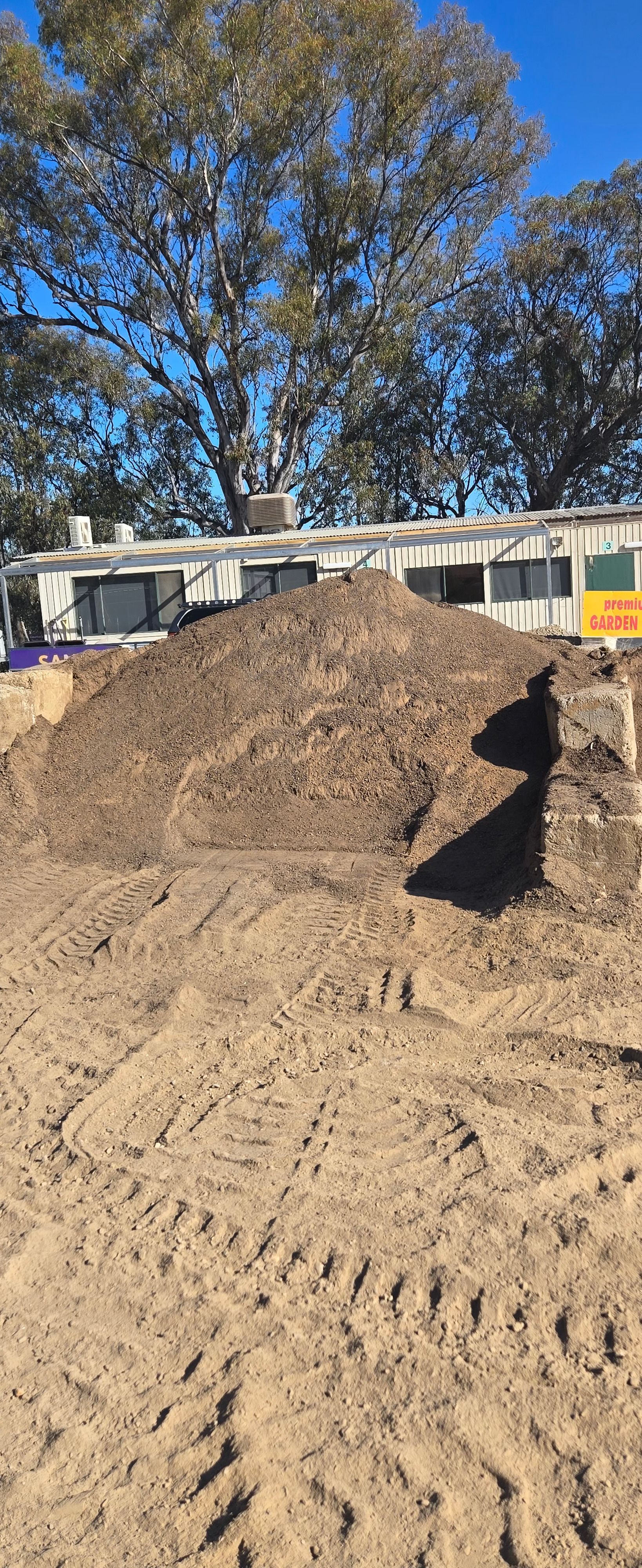 A Stone Walkway Leading to a Brick Building — Wodonga Sand & Soil in Wodonga, VIC