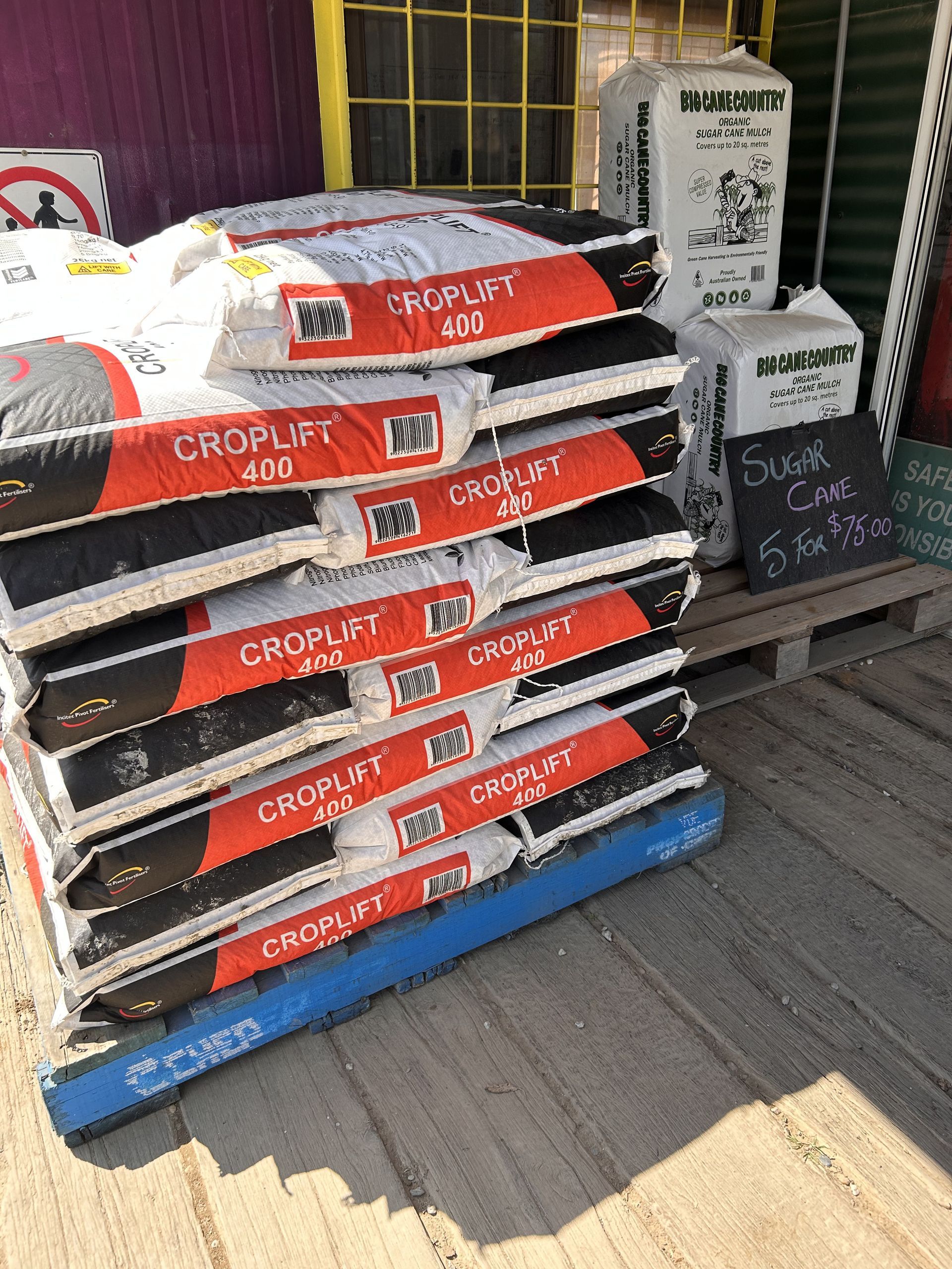 A pile of croplift bags on a wooden crate — Wodonga Sand & Soil in Wodonga, VIC