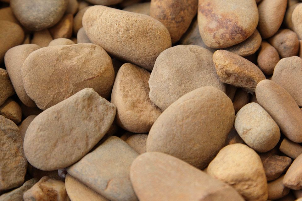 Tan, smooth river rocks piled together. — Wodonga Sand & Soil in Wodonga, VIC