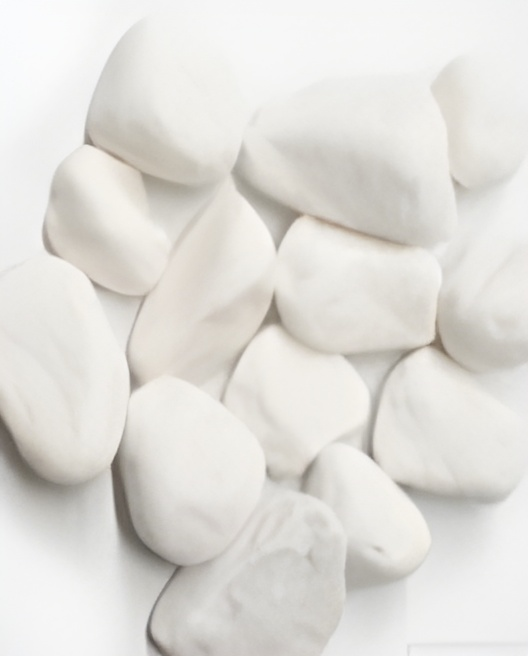 White Smooth River Rocks Scattered On A White Surface — Wodonga Sand & Soil in Wodonga, VIC