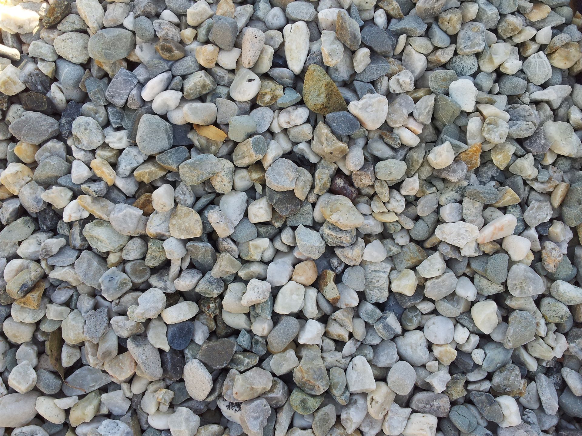 Pile of mixed-color gravel stones. Light gray, tan, and speckled stones fill the frame. — Wodonga Sand & Soil in Wodonga, VIC