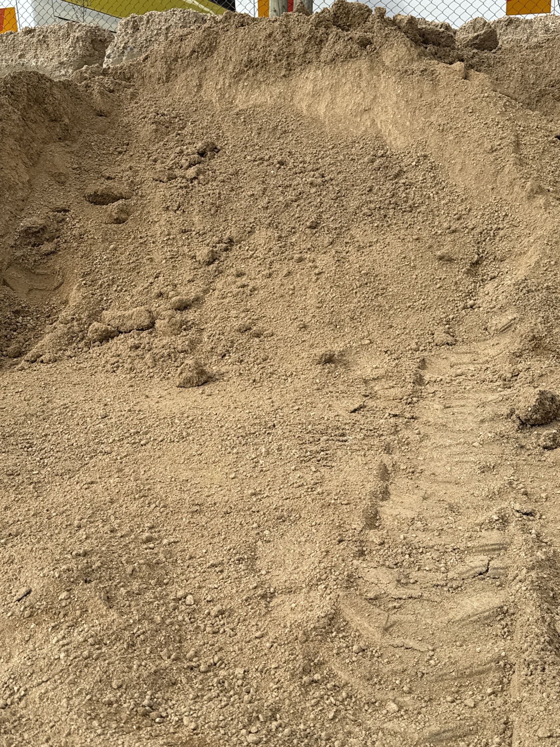 Pile of tan-colored sand, likely used for construction. Visible tire tracks are imprinted on the surface. — Wodonga Sand & Soil in Wodonga, VIC