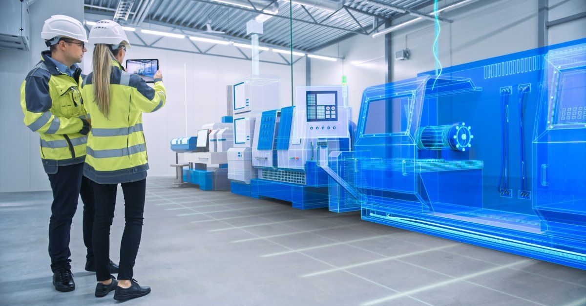 Two workers wearing high-vis jackets and hard hats in front of a 3D projection of a CNC machine.