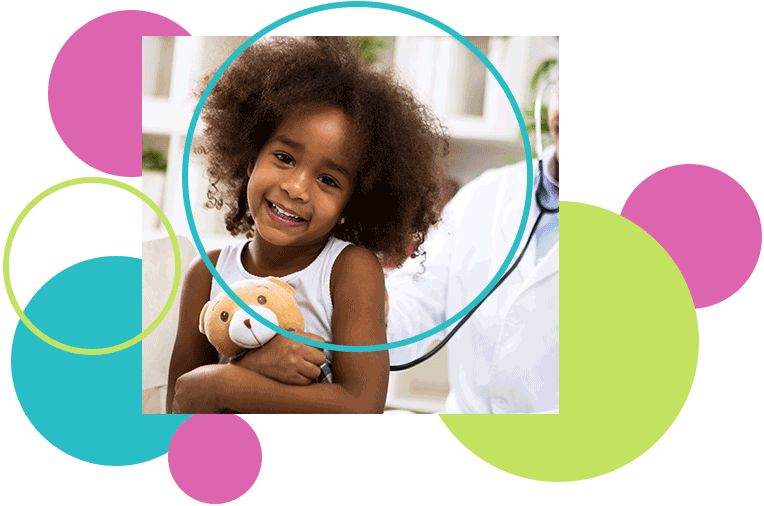 Smiling child with a toy, being examined by a doctor with a stethoscope.