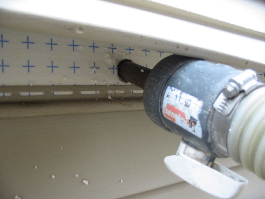 A drill is being used to drill a hole in a wall