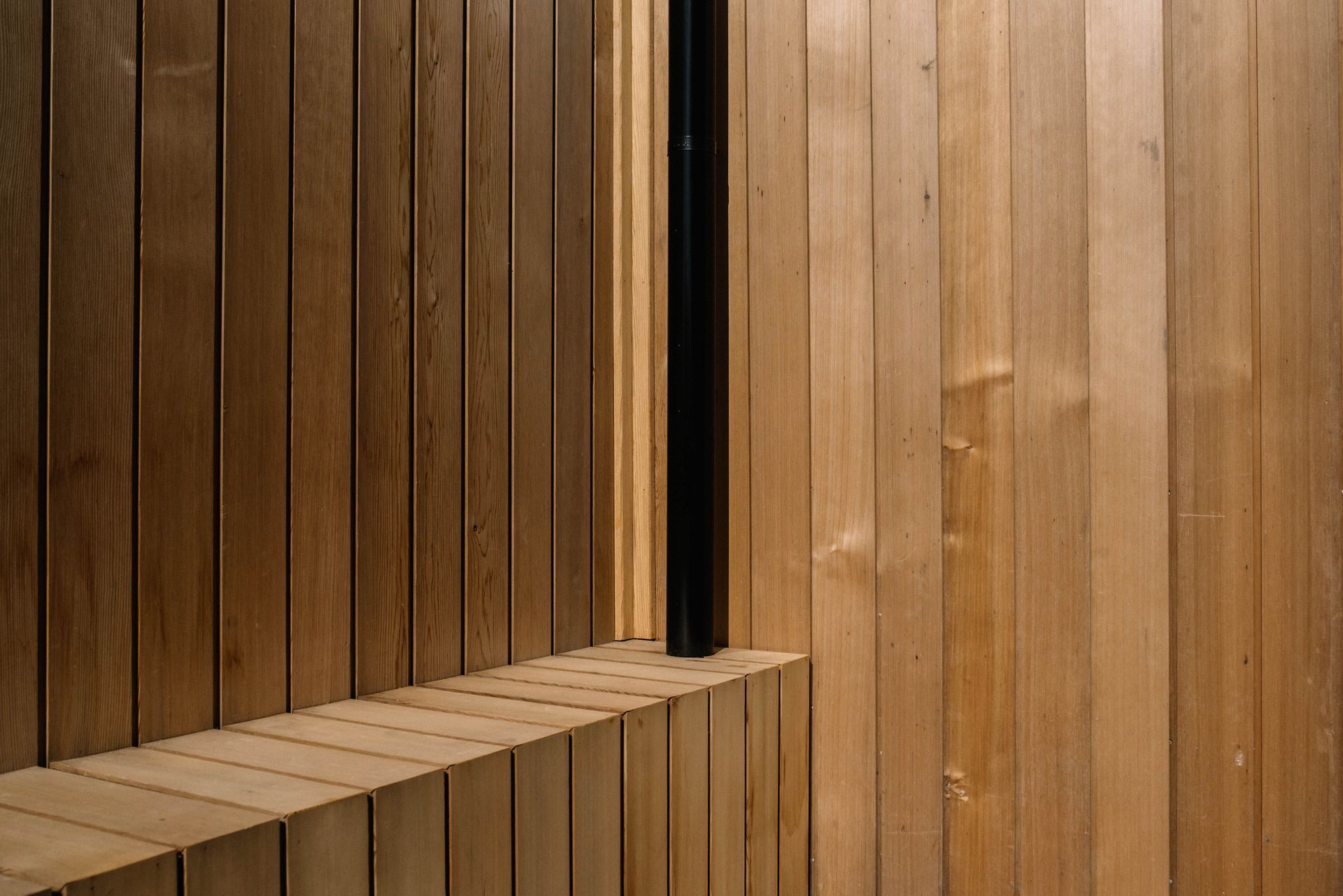 A large house with a balcony and a lot of windows is sitting on top of a lush green field in a Construction Management in Rye