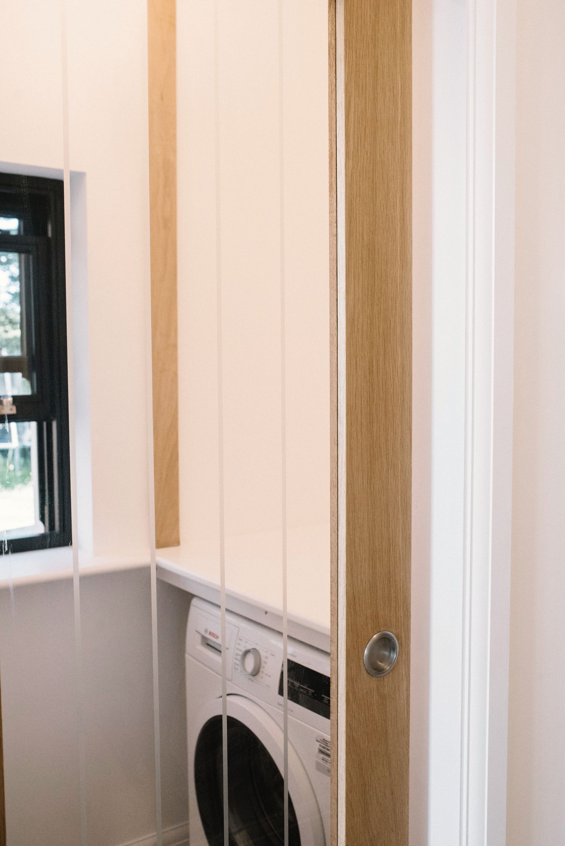 A kitchen with a sink , cabinets , and a window in a Large-Scale Retrofitting in Tenterden